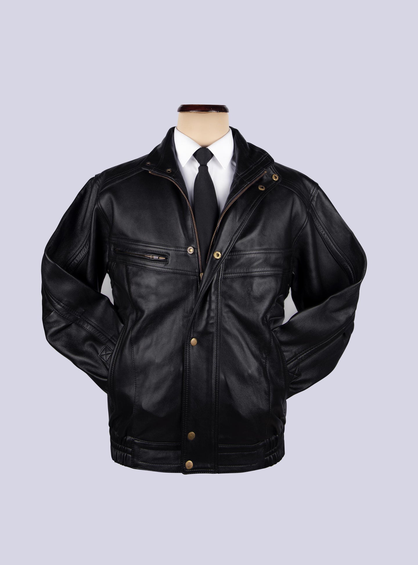 BOMBER JACKET displayed on mannequin. A white shirt and aneck tie is tucked in. Jackets hands are tucked inside slit pocket