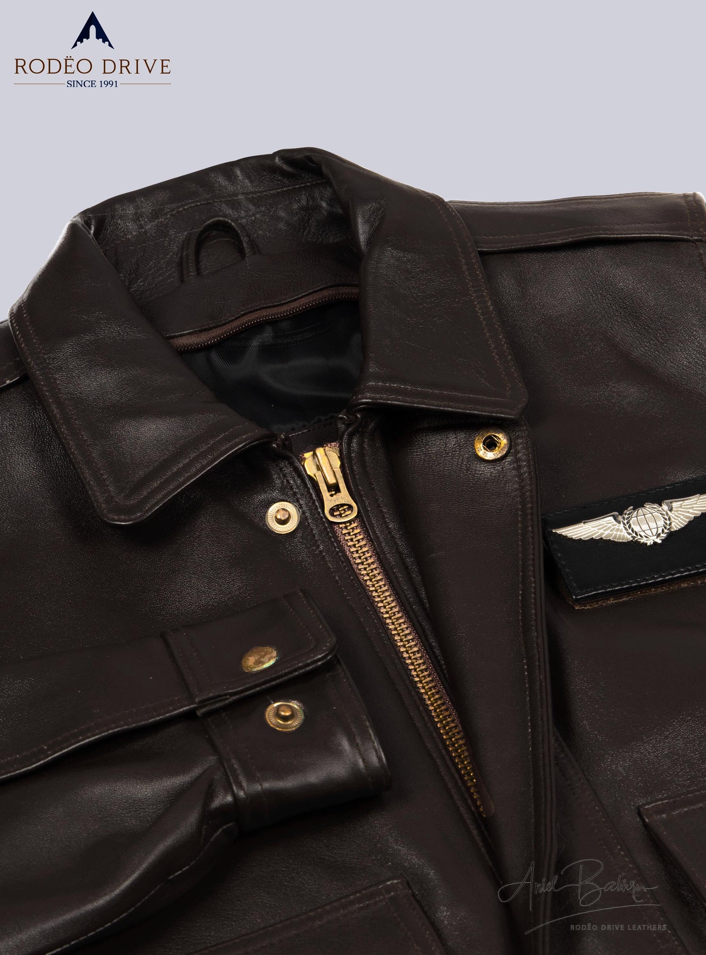 Close image of BROWN JACKETS for MEN. it is zipped and handcuff are buttoned.