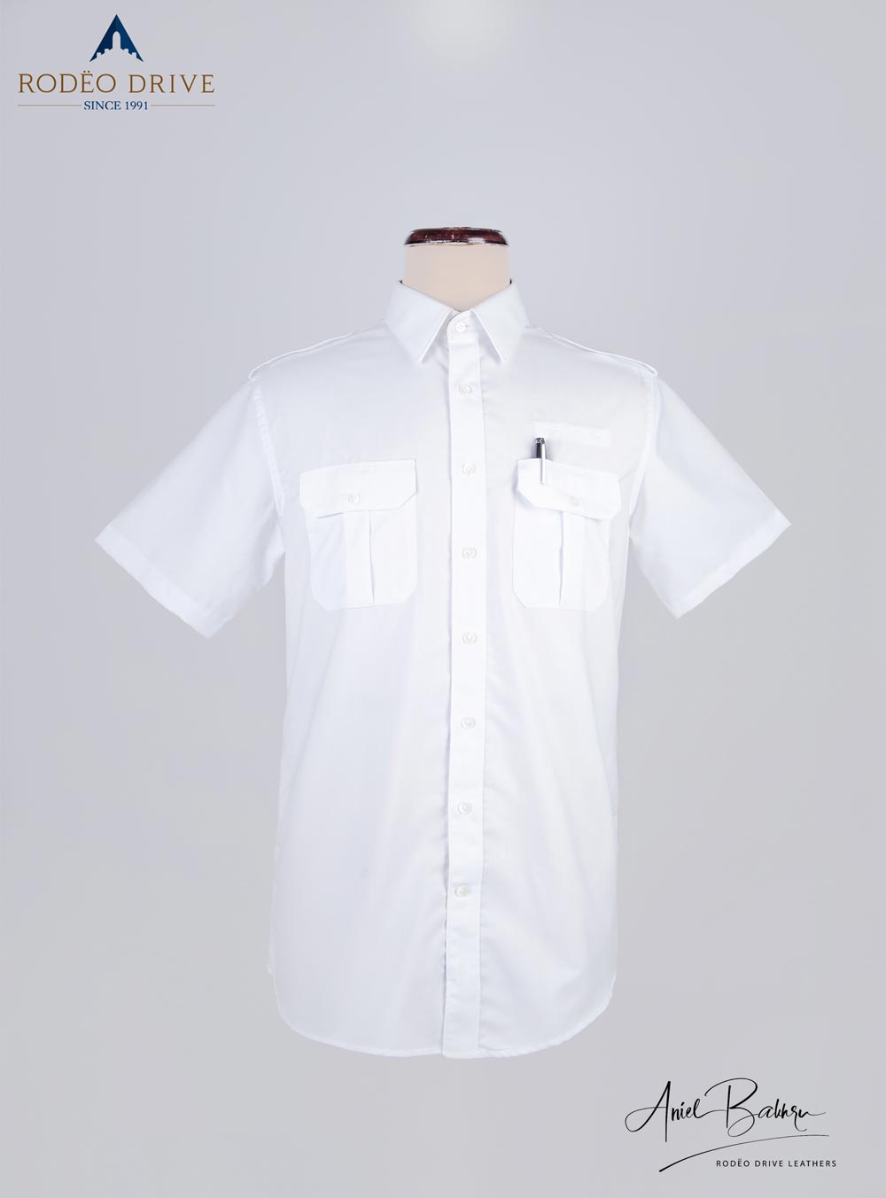 White Standard Pilot Shirt displayed on mannequin. It is buttoned. Two front pockets with Close strap visible. a pen is inserted in left pocket