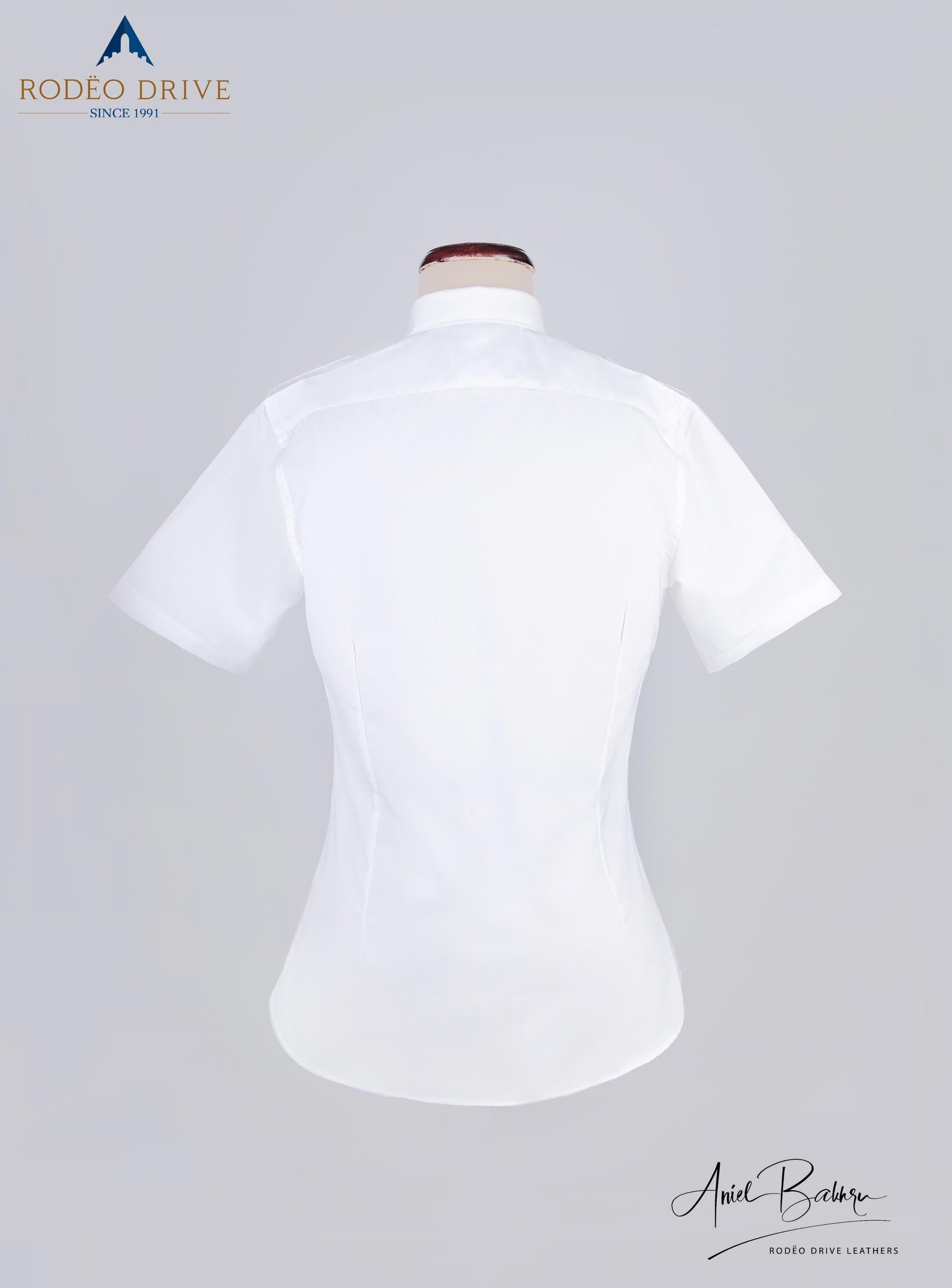 Back side image of white Women's Pilot. It is short sleeved