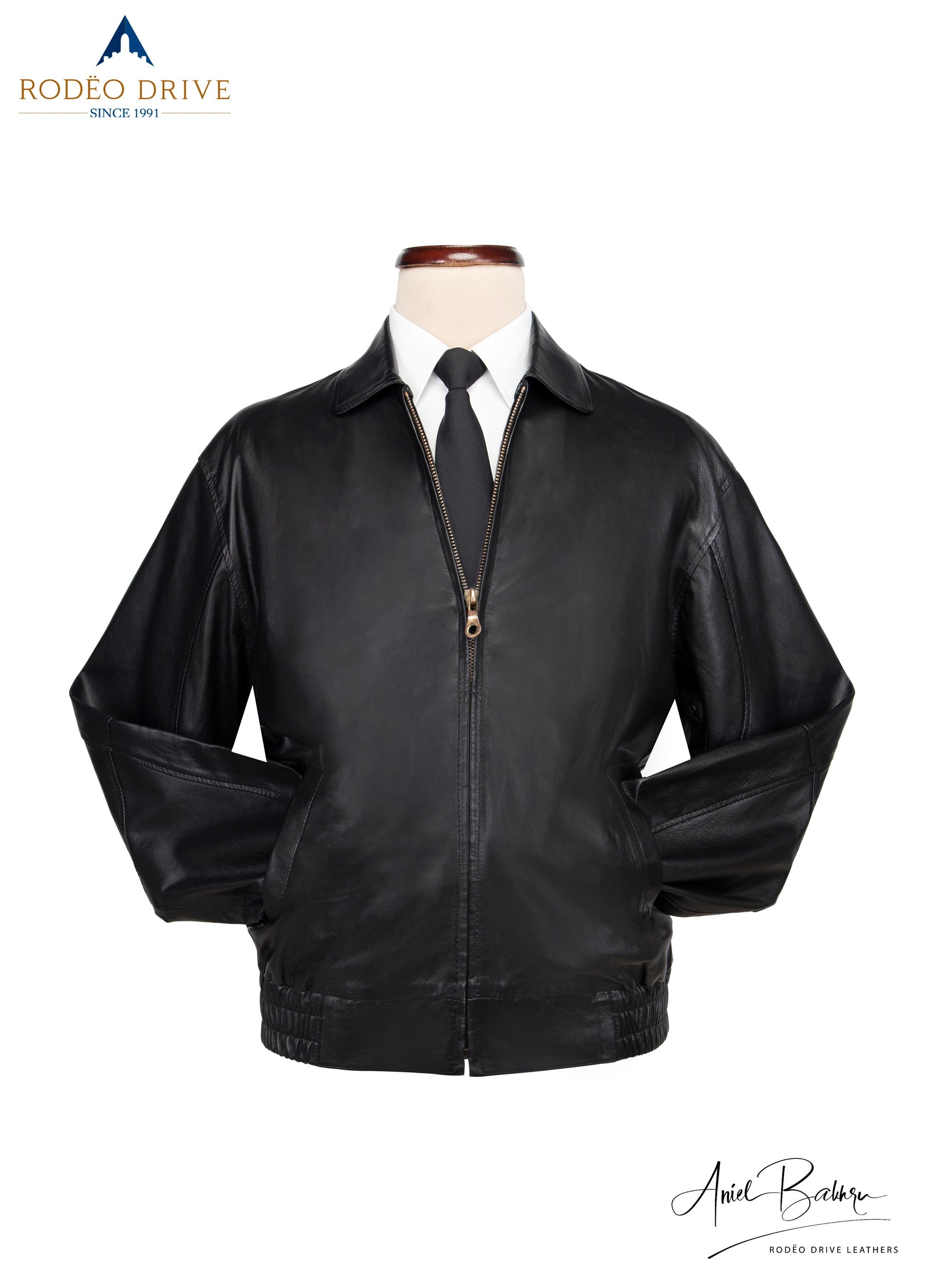 image of Bomber jacket displayed on mannequin. a white shirt and neck tie tucked inside,