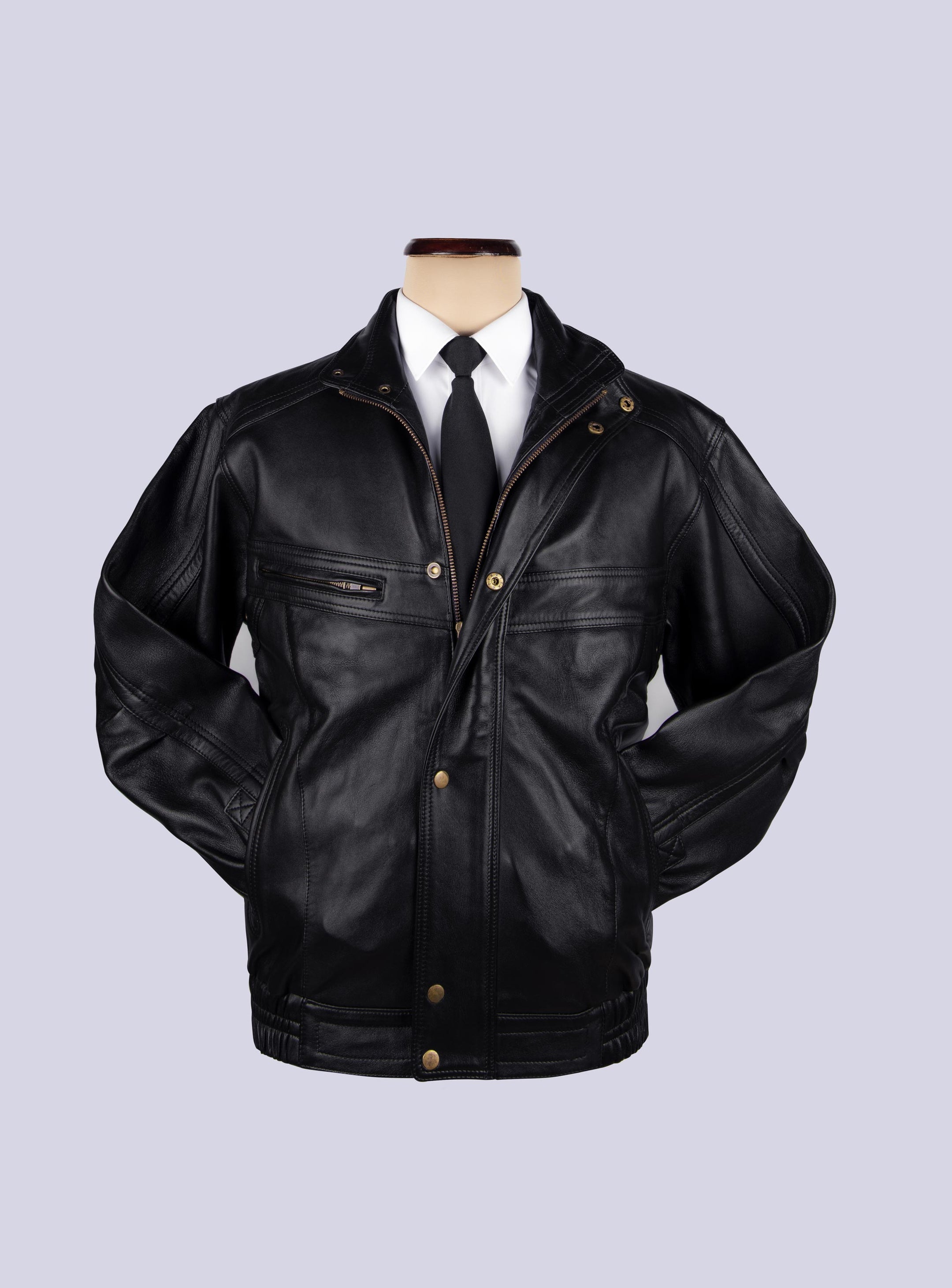 BOMBER JACKET displayed on mannequin. A white shirt and aneck tie is tucked in. Jackets hands are tucked inside slit pocket