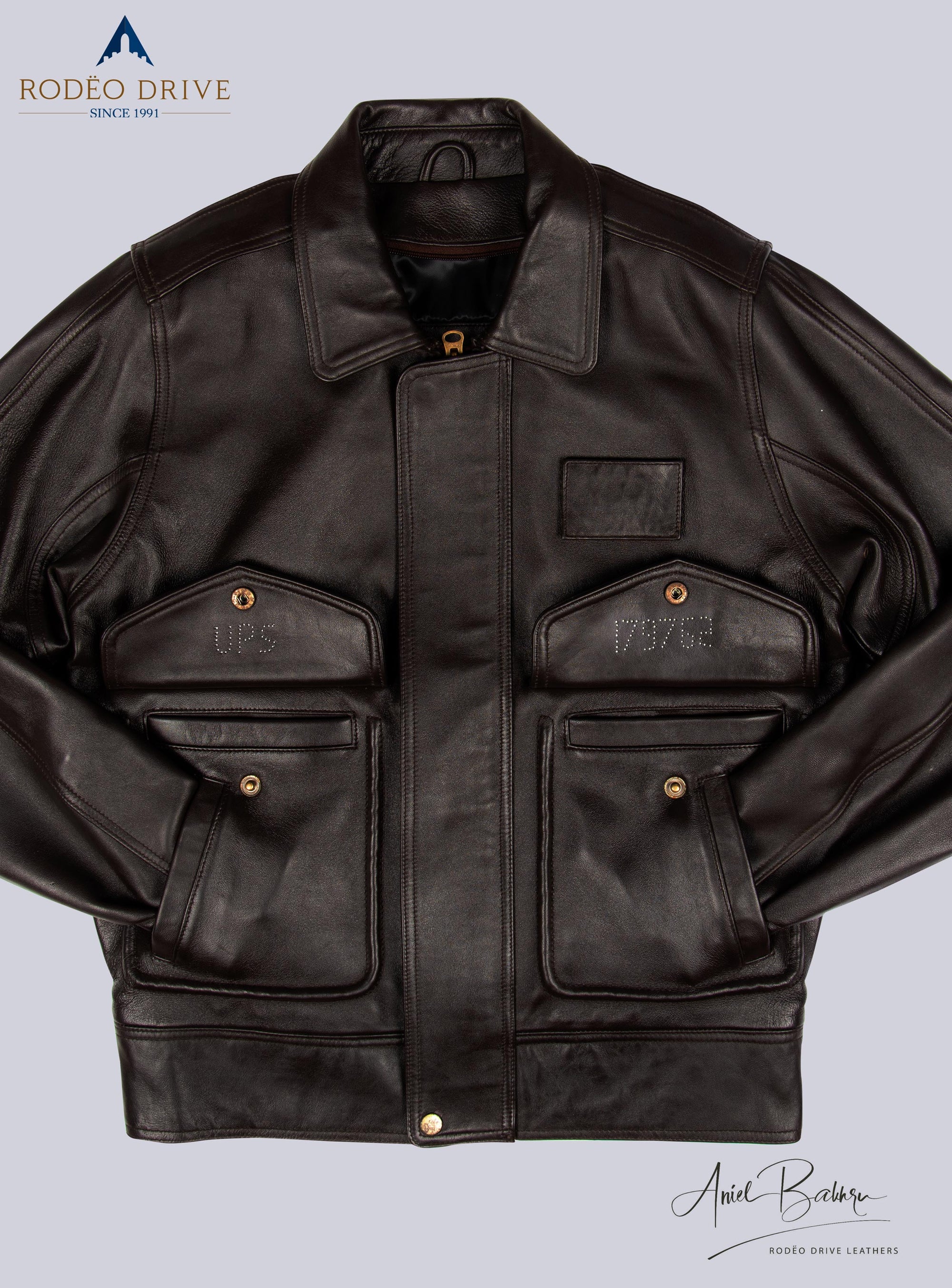 a front image of full UPS BROWN LEATHER JACKET for WOMEN. Both its hand are tucked inside slit pocket. Other to pockets has buttoned strap. It is zipped