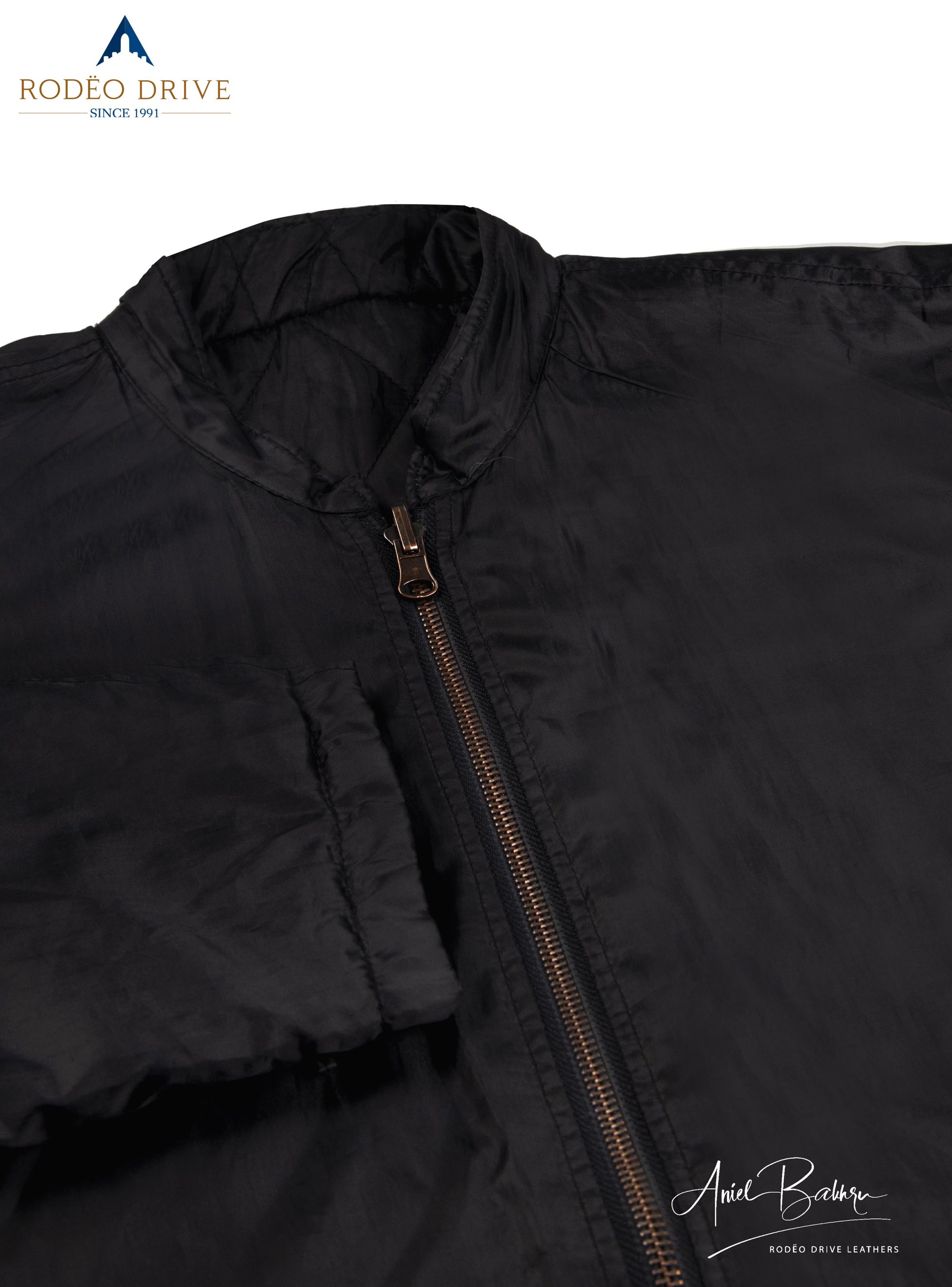 Front image of zipped plane black Jacket. It is zipped. It is close image.