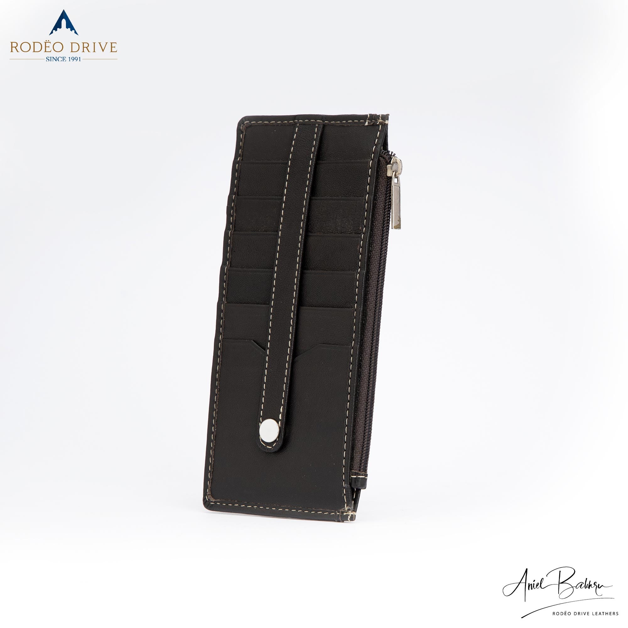 A side long view of unfolded black SWAP WALLET for WOMENS. Top compartment is zipped