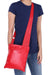 Model posing with red FLAT CROSS BODY HAND BAG