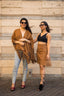 Female models posing with our tan colour SUEDE LEATHER PONCHO 