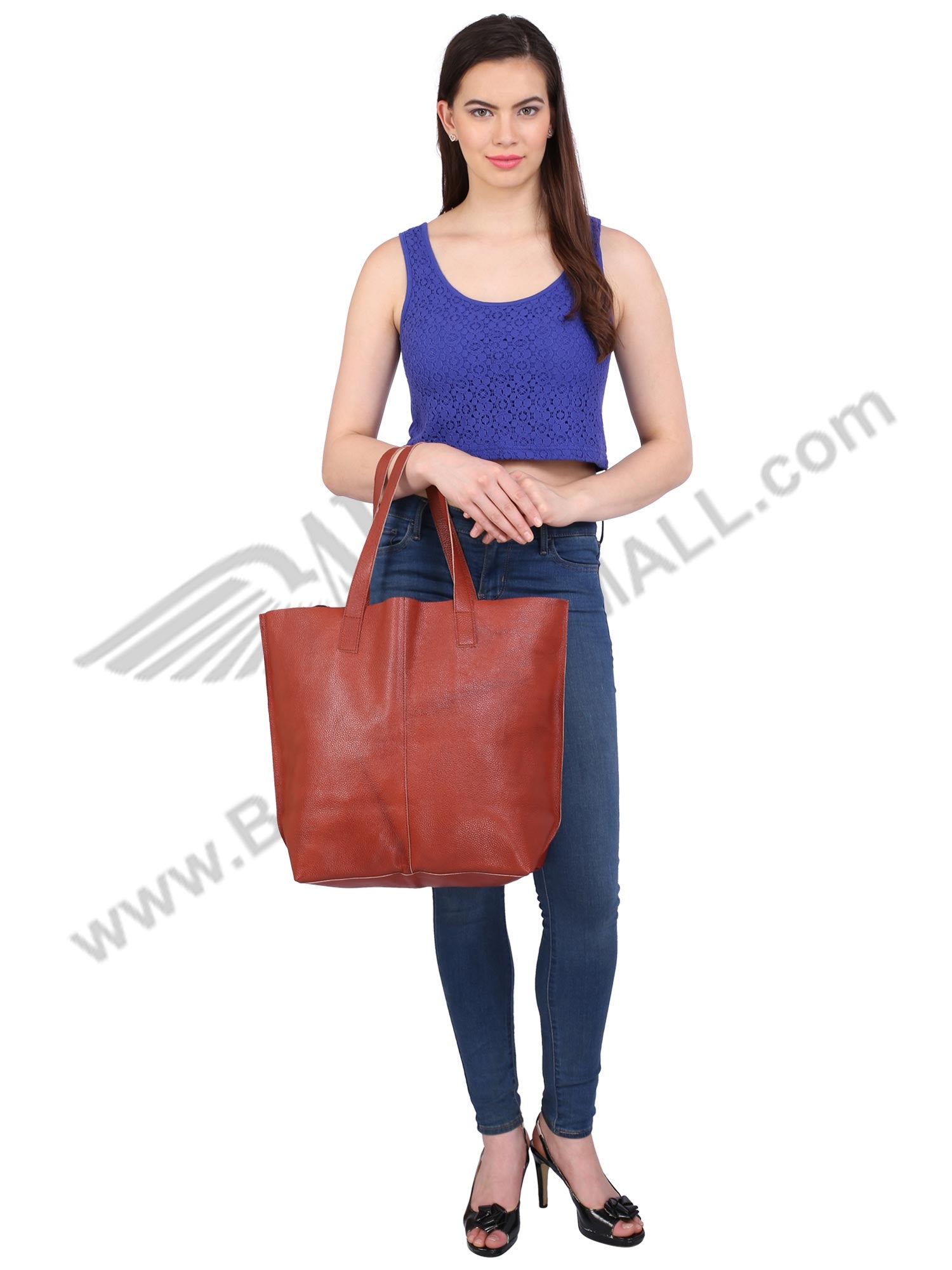 Front image of brown LUFT SHOPPING BAG. A model posing  with it.