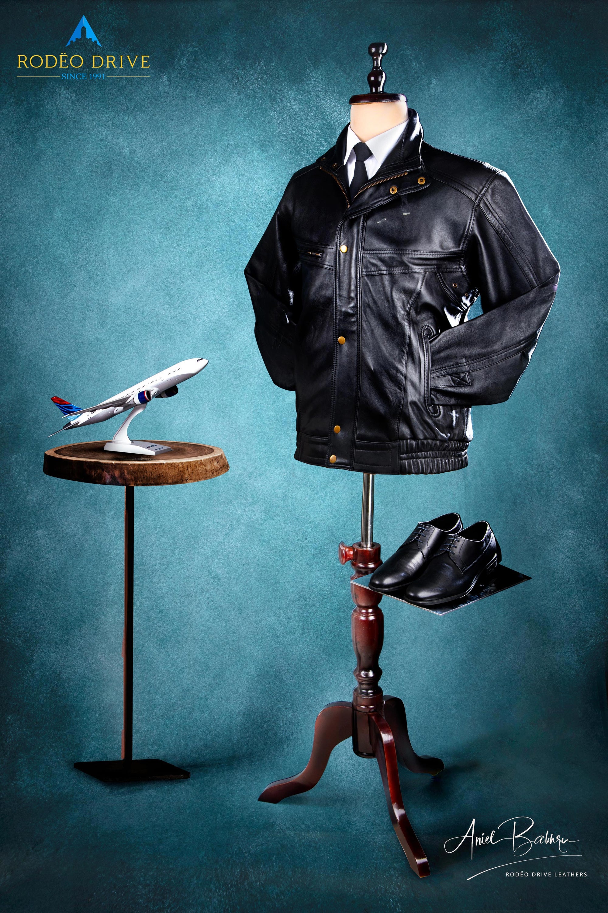Image of Pilot accesories. It includes Bomber short Jacket, Shoes and a model of plane.