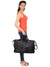 Model giving side pose with black CARRY ON TOTE SAA-SMALL