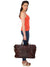 Model posing in side view with CARRY ON TOTE SAA MEDIUM SIZE